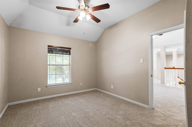 carpeted empty room with ceiling fan and vaulted ceiling