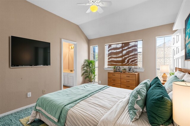 bedroom with ceiling fan, lofted ceiling, ensuite bath, and carpet