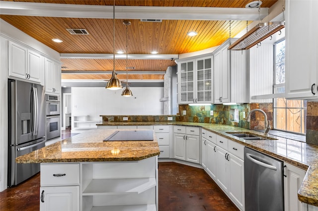 kitchen with pendant lighting, white cabinetry, stainless steel appliances, a center island, and decorative backsplash