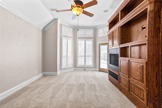 unfurnished living room with ceiling fan, light colored carpet, lofted ceiling, and crown molding