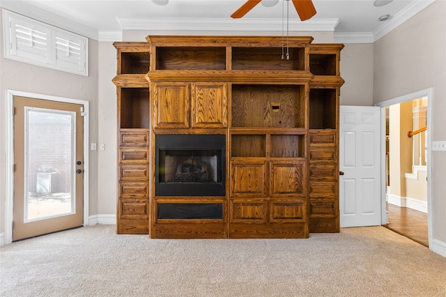 unfurnished living room featuring light carpet, crown molding, and ceiling fan