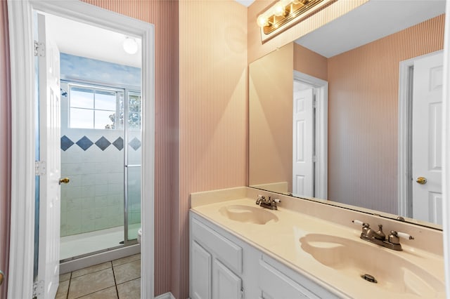 bathroom featuring walk in shower, tile patterned flooring, and vanity