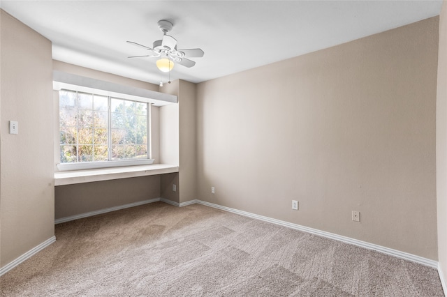 spare room featuring ceiling fan and light colored carpet