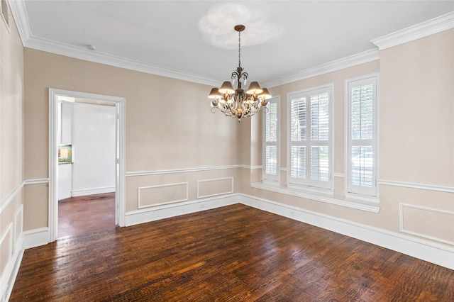 spare room with ornamental molding, a notable chandelier, and dark hardwood / wood-style floors