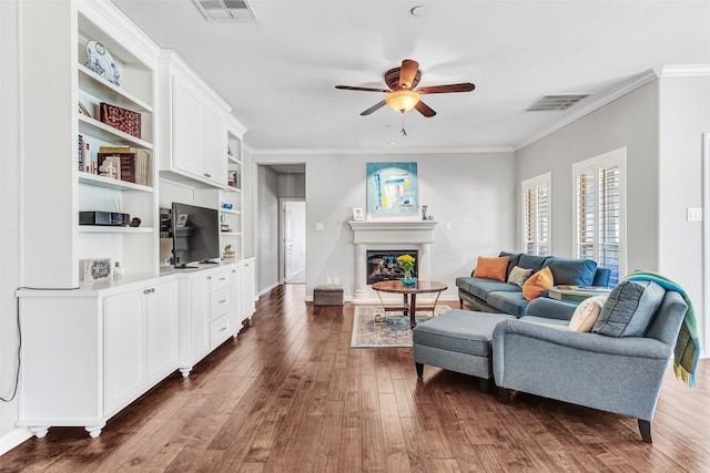 living room featuring ceiling fan, ornamental molding, and dark hardwood / wood-style floors