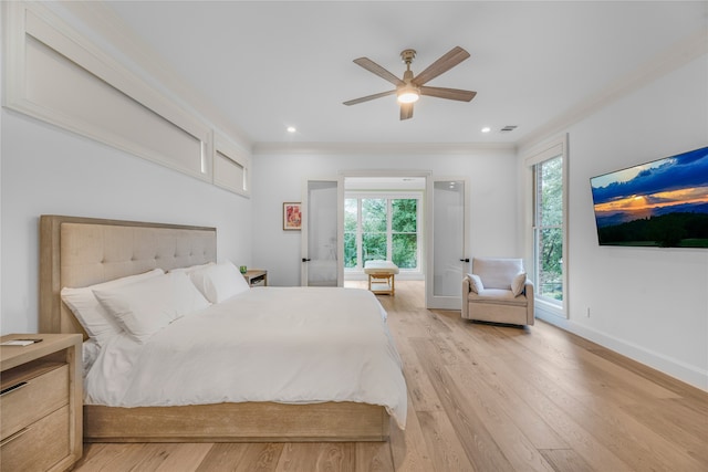 bedroom featuring ornamental molding, light wood-type flooring, and ceiling fan