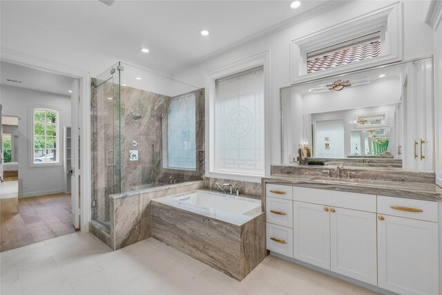 bathroom featuring crown molding, independent shower and bath, vanity, and wood-type flooring