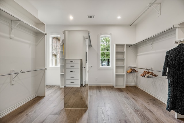 spacious closet featuring light hardwood / wood-style floors