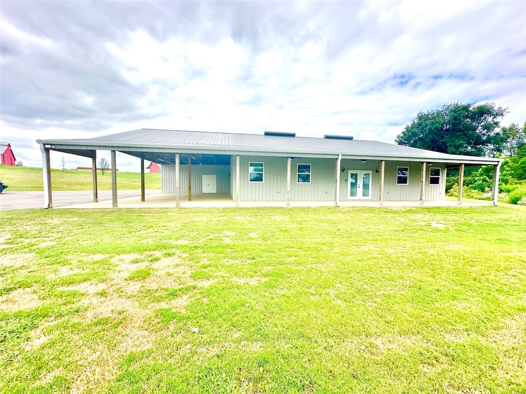 rear view of property featuring a yard