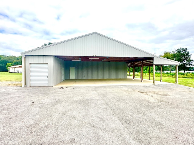 garage featuring wood walls and a carport