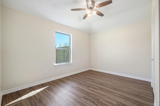 empty room with dark hardwood / wood-style flooring, ceiling fan, and lofted ceiling