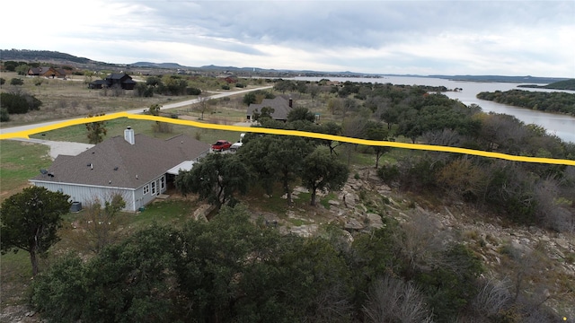 birds eye view of property with a water and mountain view