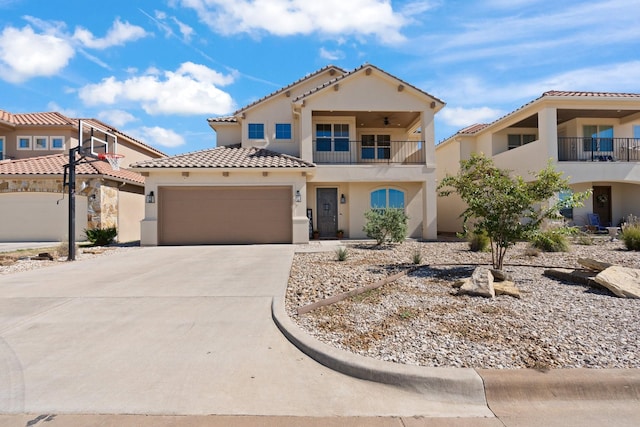 135 Valley Vw, Glen Rose, TX 76043 - mediterranean / spanish house featuring a balcony, stucco siding, a tile roof, driveway, and an attached garage