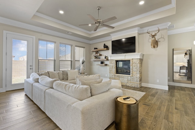 living room with a fireplace, wood-type flooring, plenty of natural light, and ornamental molding