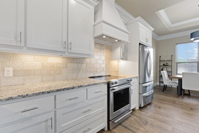135 Valley Vw, Glen Rose, TX 76043 - kitchen with stainless steel appliances, premium range hood, wood finished floors, white cabinets, and crown molding