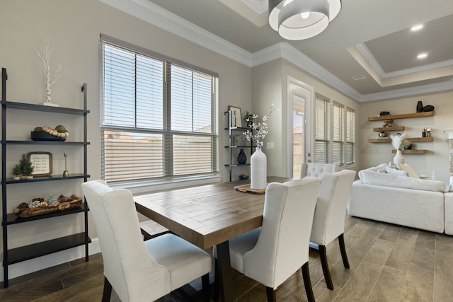 dining space with wood-type flooring and crown molding