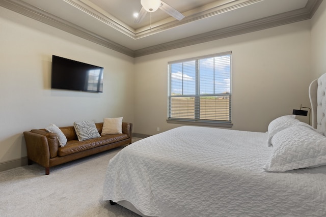 carpeted bedroom featuring ceiling fan, crown molding, and a tray ceiling