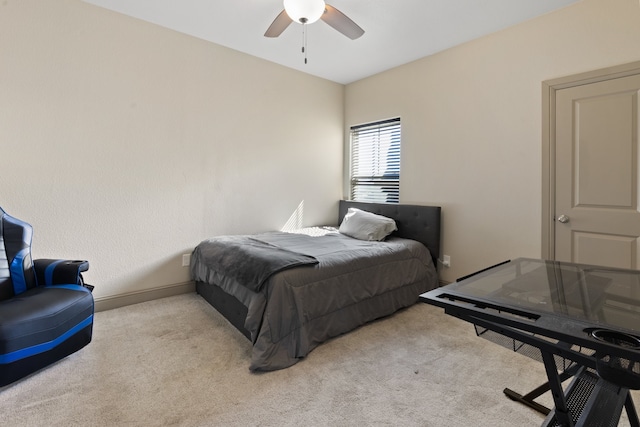 bedroom featuring light colored carpet and ceiling fan