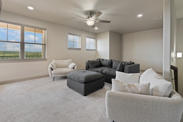 carpeted living room with ceiling fan