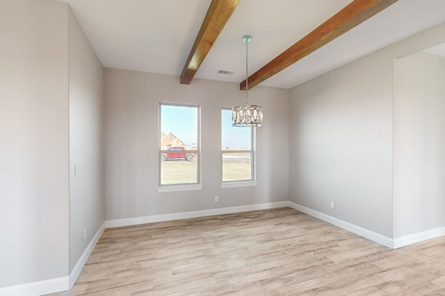 spare room featuring beam ceiling, light wood-type flooring, and a chandelier