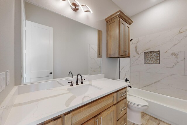 full bathroom with vanity, toilet, and tiled shower / bath combo