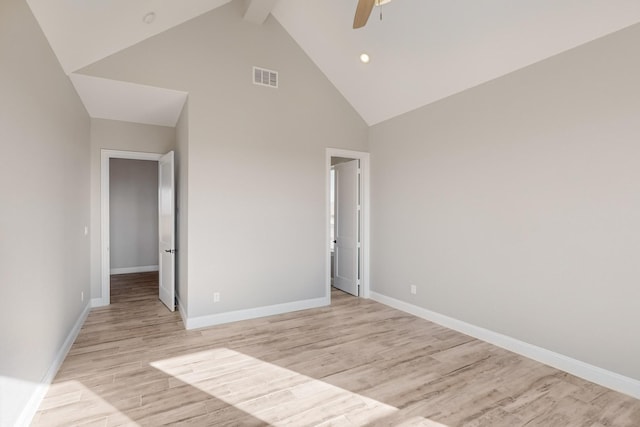 unfurnished bedroom featuring beam ceiling, ceiling fan, light hardwood / wood-style flooring, and high vaulted ceiling