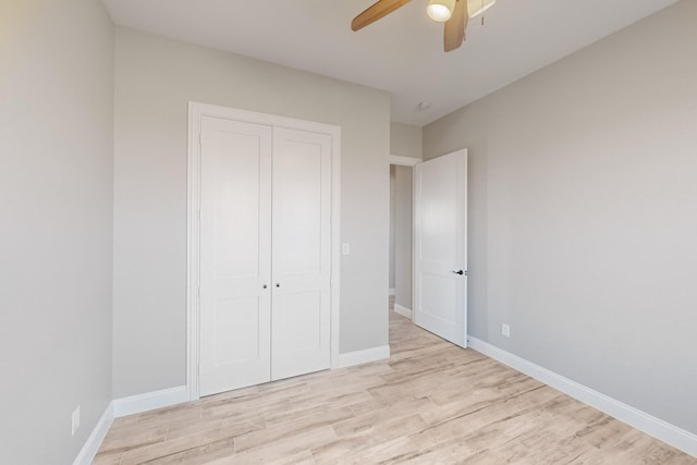 unfurnished bedroom with a closet, ceiling fan, and light hardwood / wood-style flooring