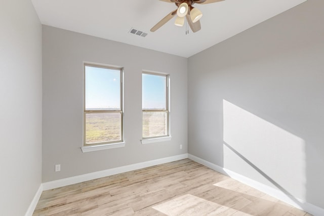 empty room featuring ceiling fan and light hardwood / wood-style flooring