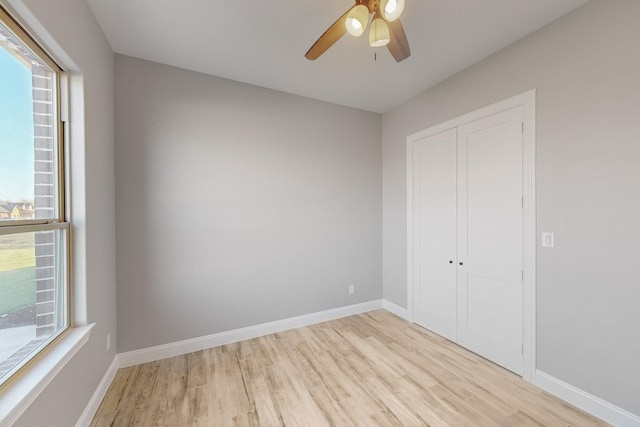 unfurnished bedroom with ceiling fan, a closet, and light hardwood / wood-style flooring