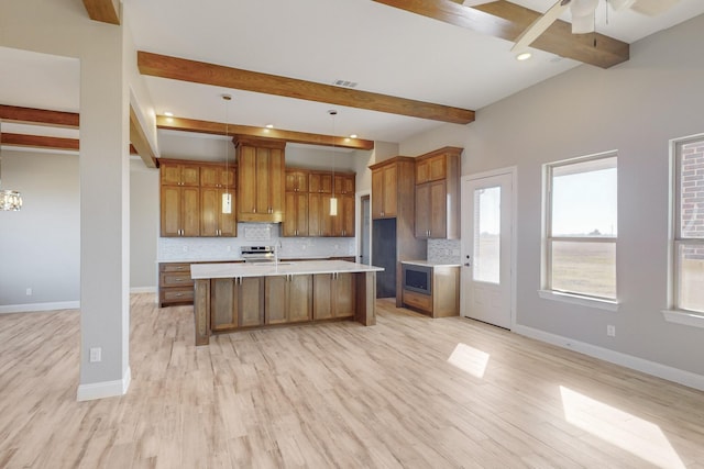 kitchen with backsplash, beam ceiling, and hanging light fixtures