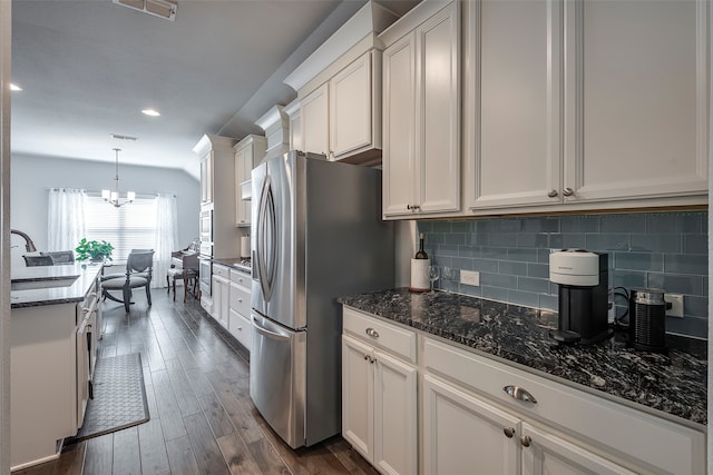 kitchen featuring pendant lighting, white cabinetry, sink, and dark hardwood / wood-style flooring