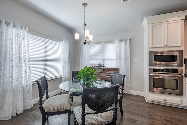 dining room with a notable chandelier and dark hardwood / wood-style floors