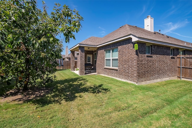 back of house featuring a yard