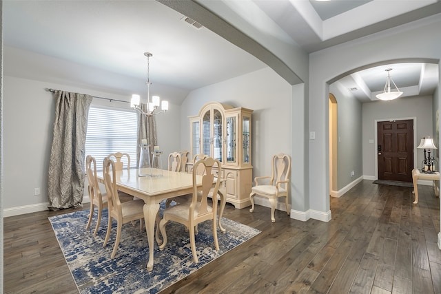 dining space featuring a notable chandelier and dark hardwood / wood-style floors