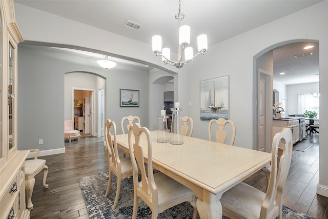 dining room featuring a chandelier and dark wood-type flooring