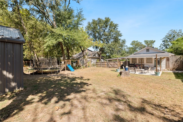 view of yard with a patio and a trampoline