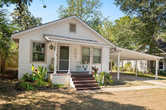 505 S Boyd, Lindale, TX 75771 - bungalow-style home with driveway, an attached carport, and covered porch