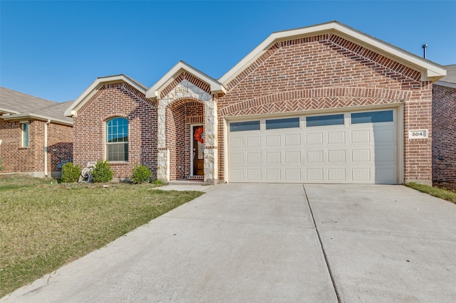 view of front of home with a front yard and a garage