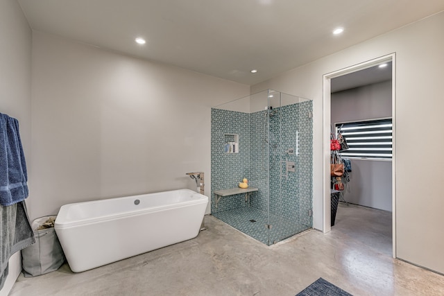 bathroom featuring concrete flooring and independent shower and bath