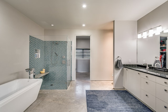 bathroom with vanity, concrete flooring, and shower with separate bathtub