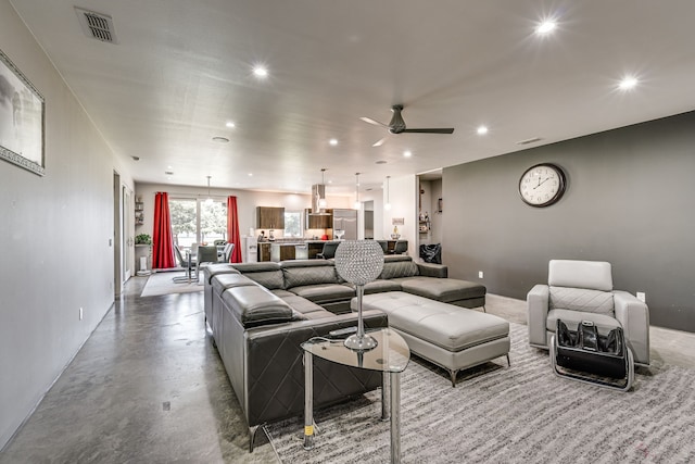 living room featuring ceiling fan and concrete floors