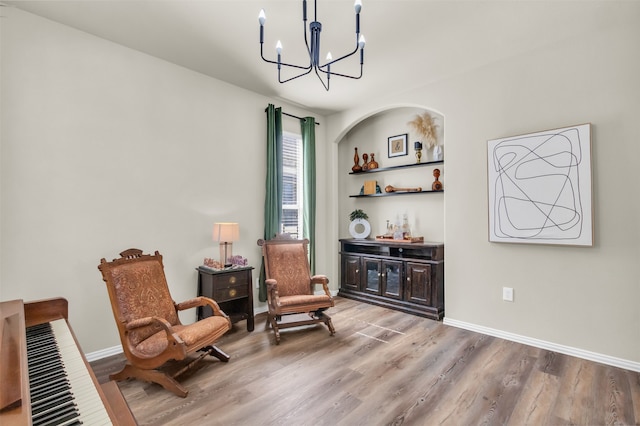 living area with hardwood / wood-style floors and a notable chandelier