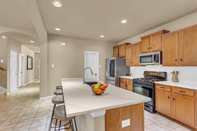 living room featuring a tiled fireplace, ceiling fan, and light tile patterned floors