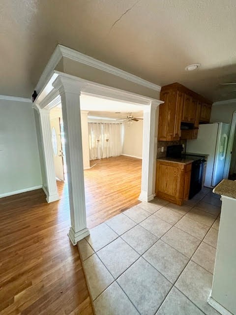 kitchen featuring light hardwood / wood-style flooring, decorative columns, ceiling fan, and crown molding