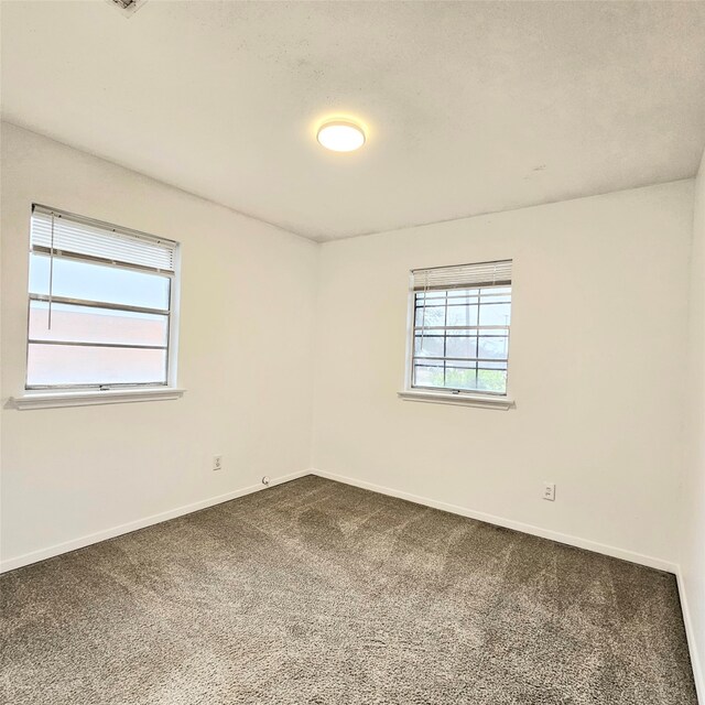 unfurnished bedroom featuring light colored carpet and ensuite bath