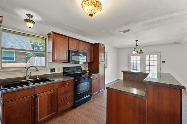 kitchen with sink, a center island, french doors, black appliances, and light wood-type flooring