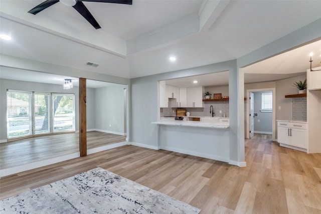 2625 Mollimar Dr, Plano, TX 75075 - kitchen with white cabinets, visible vents, ceiling fan, light countertops, and light wood-style floors
