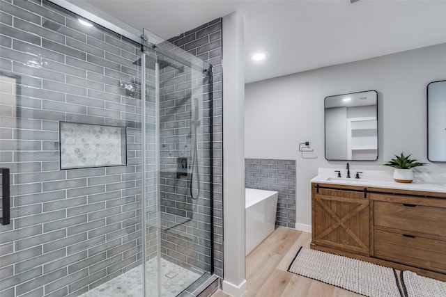 bathroom featuring wood-type flooring, vanity, and independent shower and bath