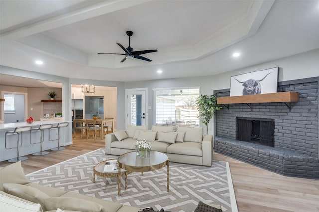 2625 Mollimar Dr, Plano, TX 75075 - living room featuring ceiling fan with notable chandelier, recessed lighting, a healthy amount of sunlight, and light wood-style flooring