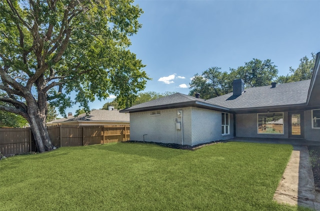 rear view of property with a yard